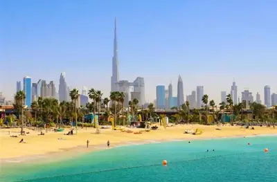 a beach in dubai with a city in the background at Room with bathroom near beach walk la mer beach Oima leasing property in Dubai