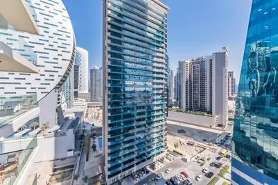 an aerial view of a tall building in a city at Exclusive Promo Modern 1BR with Partial Canal Views by Deluxe Holiday Homes in Dubai