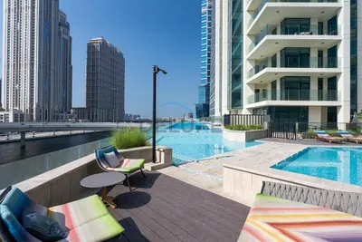 a view of a swimming pool on a building at Exclusive Promo Modern 1BR with Partial Canal Views by Deluxe Holiday Homes in Dubai