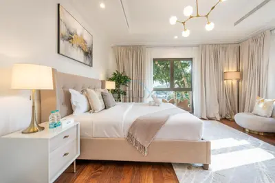 a bedroom with a large white bed and a window at Beach Access Villa with Backyard in Prime Location in Canal Cove, Palm Jumeirah by Deluxe Holiday Homes in Dubai