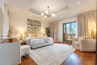 a bedroom with a bed and a couch and a chair at Beach Access Villa with Backyard in Prime Location in Canal Cove, Palm Jumeirah by Deluxe Holiday Homes in Dubai