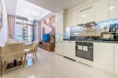 a kitchen with a table and chairs and a stove at Limited Time Offer Tranquil 1BR in Business Bay by Deluxe Holiday Homes in Dubai