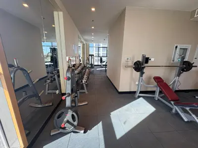 a gym with treadmills and machines in a building at Dubai damac hills luxurious appartment in Dubai
