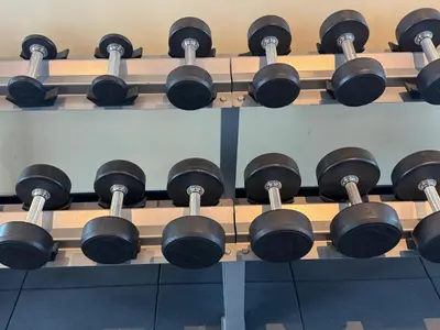 a rack of dumbbells in a gym at Dubai damac hills luxurious appartment in Dubai