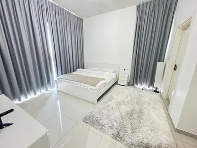 a white room with a bed and a large window at Dubai damac hills luxurious appartment in Dubai