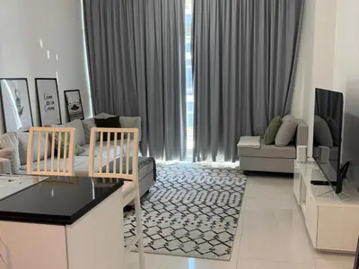 a living room with two chairs and a couch at Dubai damac hills luxurious appartment in Dubai