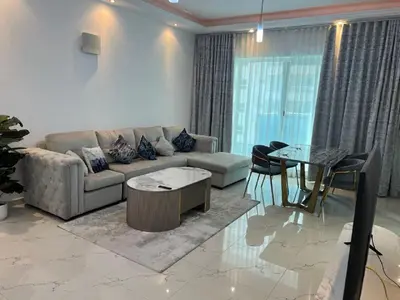 a living room with a couch and a table at Opal Tower in Dubai