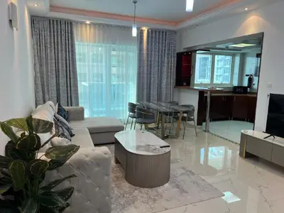 a living room with a couch and a table at Opal Tower in Dubai