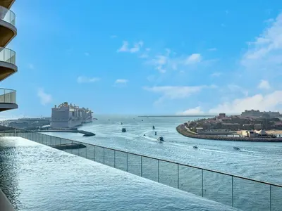 a view of the ocean from a balcony of a building at Exclusive Beachfront 2 Bed with Pool & Palm View in Dubai