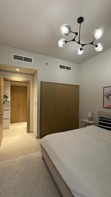a bedroom with a large bed and a kitchen at 1bedroom Apartment With Stunning view Creek Harbour in Dubai