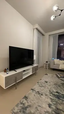 a living room with a large flat screen tv at 1bedroom Apartment With Stunning view Creek Harbour in Dubai