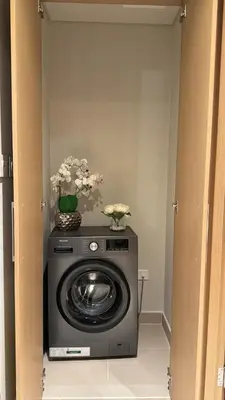 a washing machine with flowers on top of it at 1bedroom Apartment With Stunning view Creek Harbour in Dubai
