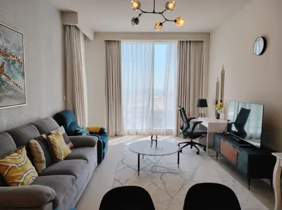 a living room with a couch and a table at Stunning 1BR Apartment High floor Creek Harbour in Dubai