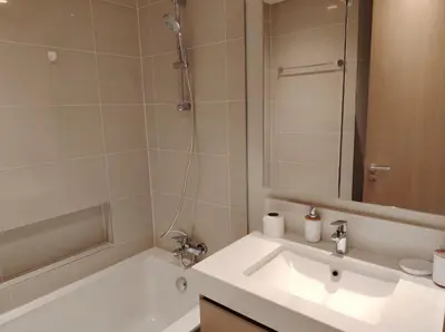 a bathroom with a tub and a sink and a mirror at Stunning 1BR Apartment High floor Creek Harbour in Dubai