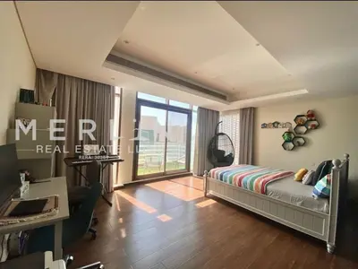 a bedroom with a bed and a desk and a window at Luxurious Meydan Dubai 6 BED Villa Unparalleled Views in Dubai