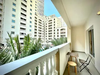 a balcony with a view of a building at Modern 1BR Retreat with Balcony in Vibrant JVC by Bhavan Vacation Homes in Dubai