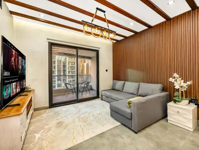 a living room with a couch and a flat screen tv at Luxury 2BR Apartment with Full Marina Views in Dubai