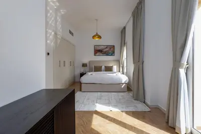 a bedroom with a bed in a white room at Family Friendly - 2BR & Maid's Room in The Springs 10 - Allsopp & Allsopp in Dubai