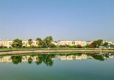 a large body of water with buildings in the background at Family Friendly - 2BR & Maid's Room in The Springs 10 - Allsopp & Allsopp in Dubai