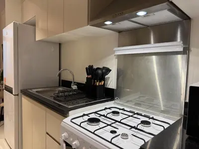 a kitchen with a stove top oven in a kitchen at ASHRI Studio in Carson C, Damac Hills 1 in Dubai