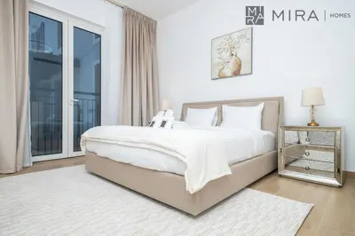 a bedroom with a large bed and a window at Mira Holiday Homes - Newly 2 bedroom in La Sirene, Port De La Mer in Dubai