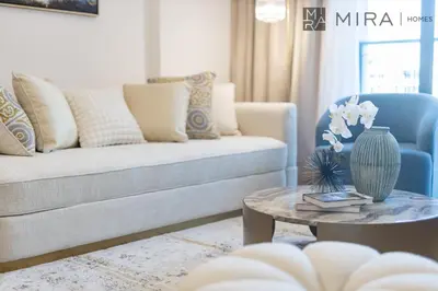 a living room with a couch and a table at Mira Holiday Homes - Newly 2 bedroom in La Sirene, Port De La Mer in Dubai
