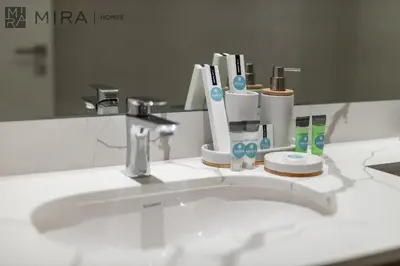 a bathroom sink with toothbrushes and toothpaste at Mira Holiday Homes - Newly 2 bedroom in La Sirene, Port De La Mer in Dubai