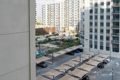 a view of a parking lot from the window of a building at Comfortable Stylish Haven - Great Community in Dubai