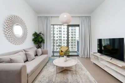 a living room with a couch and a tv at Comfortable Stylish Haven - Great Community in Dubai