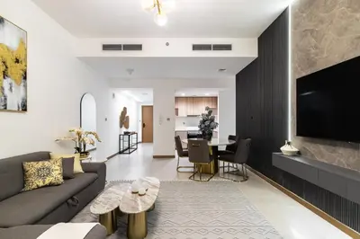 a living room with a couch and a table at SIMPLY COMFORT in Missoni Top Floor with Sea, Canal and Burj Khalifa Views in Dubai