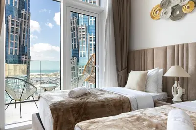 a hotel room with two beds and a large window at SIMPLY COMFORT in Missoni Top Floor with Sea, Canal and Burj Khalifa Views in Dubai
