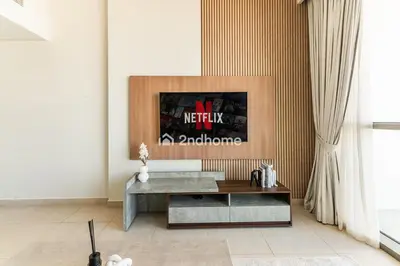 a living room with a couch and a table at Downtown Views 1 A Direct Access to Dubai Mall in Dubai
