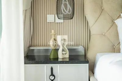 a bedroom with a table with two bottles on it at Downtown Views 1 A Direct Access to Dubai Mall in Dubai