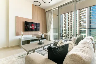 a living room with a couch and a table at Downtown Views 1 A Direct Access to Dubai Mall in Dubai