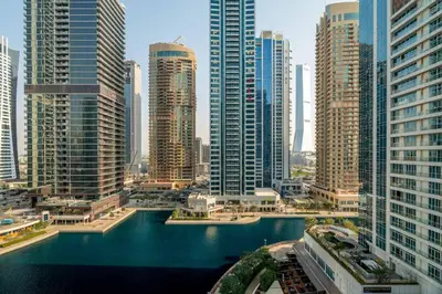 a view of a large city with tall buildings at GuestReady - Magnificent stay with lake view in Dubai