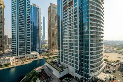 an aerial view of a city with tall buildings at GuestReady - Magnificent stay with lake view in Dubai