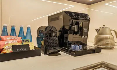 a coffeemaker sitting on a counter next to a coffee maker at 2BR Jumeirah Gate 1, Marina Skyline View in Dubai