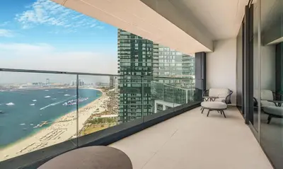 a balcony in a building with a view of the ocean at 2BR Jumeirah Gate 1, Marina Skyline View in Dubai