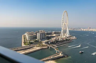 an aerial view of a city with a ferris wheel at 2BR Jumeirah Gate 1, Marina Skyline View in Dubai