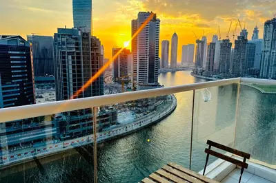 a view of a city from the balcony of a building at Vserve Stylish Suite 1 BR with Burj Khalifa and Canal view in Dubai