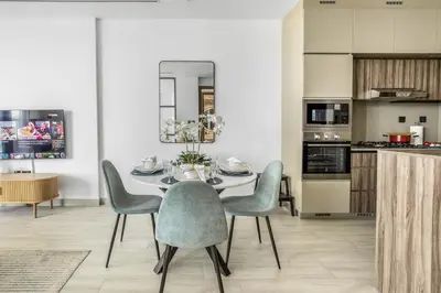 a dining room with a table and chairs at Comfy 1BR w Cinema Room Business Centre Pool Table and Sauna in Dubai