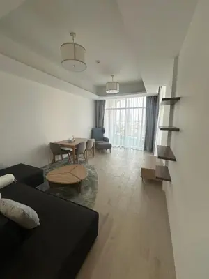 a living room with a couch and a table at Azizi Mina in Dubai