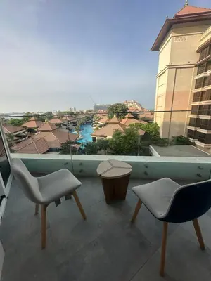 a balcony with chairs and a view of a city at Azizi Mina in Dubai