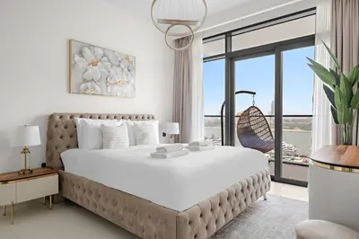a bedroom with a large bed with a large window at Silkhaus Seaside 2BDR in Marina Vista Beachfront in Dubai