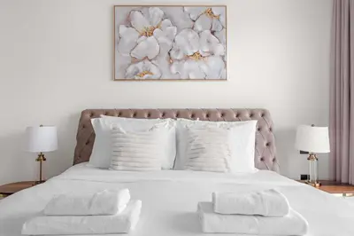 a bedroom with a white bed with white pillows at Silkhaus Seaside 2BDR in Marina Vista Beachfront in Dubai