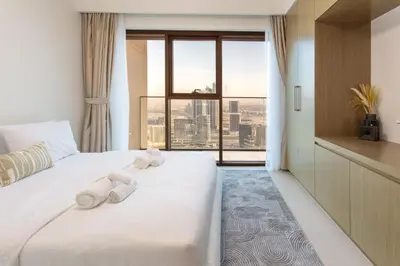a hotel room with a bed with towels on it at Prime Downtown Location 2BR Apt Burj Royale in Dubai