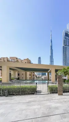 a large building with a fence and some buildings at Prime Downtown Location 2BR Apt Burj Royale in Dubai