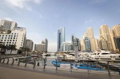 a marina with boats in a city with tall buildings at Stunning 1BR in heart of Dubai Marina in Dubai