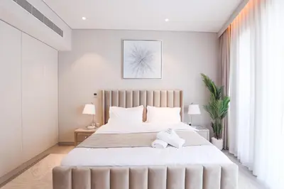 a bedroom with a large bed with white sheets at Stunning 1BR in heart of Dubai Marina in Dubai