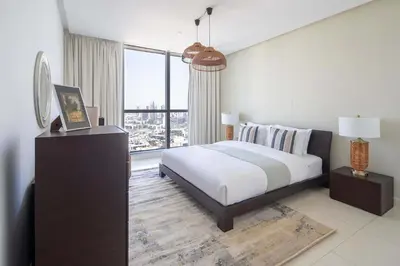 a bedroom with a bed and a large window at Frank Porter - 23 Marina in Dubai